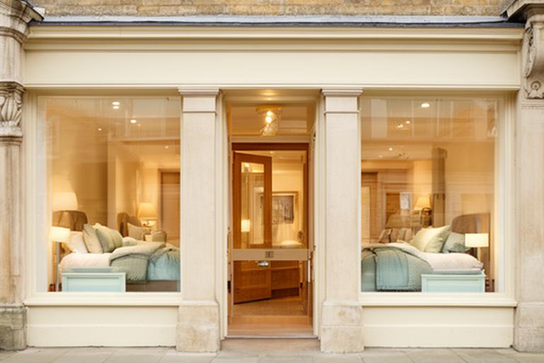Front entrance of a Buckingham bedding showroom with a clear customer welcome sign
